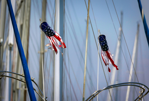 A patriotic windsock, attached to rigging on a sailboat, blows in the wind at Glorietta Bay in Coronado, California.