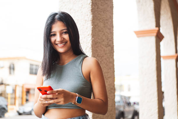 istock Young latin american woman using smartphone. 1415862795
