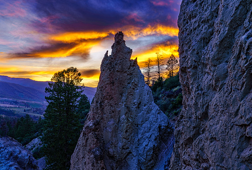 Rock Formation in Mountain Canyon - Sunset colors scenic view with mysterious looking silhouetted rock formation.