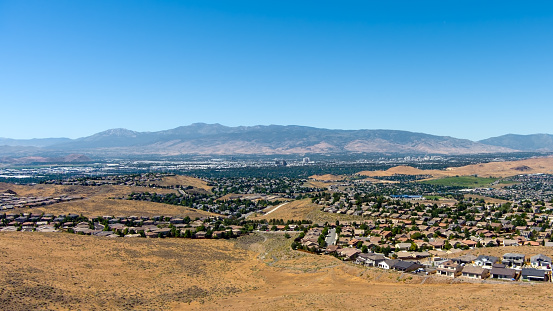 Aerial view of a residential district neighborhood in the mountains near Reno Sparks Nevada on a sunny day with a clear blue sky.