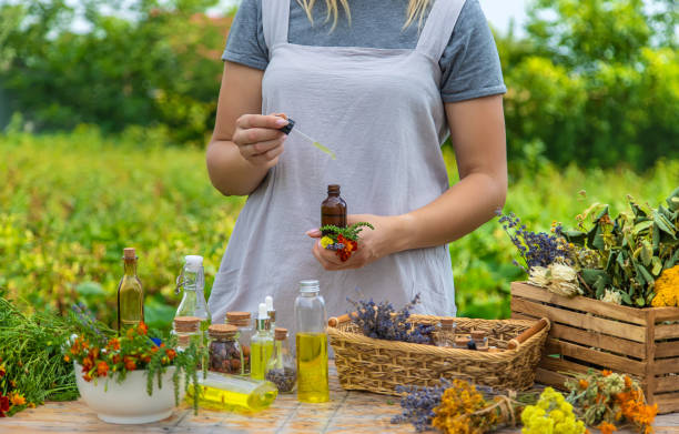 istock Woman with medicinal herbs and tinctures. Selective focus. 1415863917