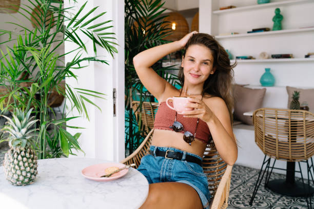 istock Stylish woman drinking coffee in cafe 1415864302