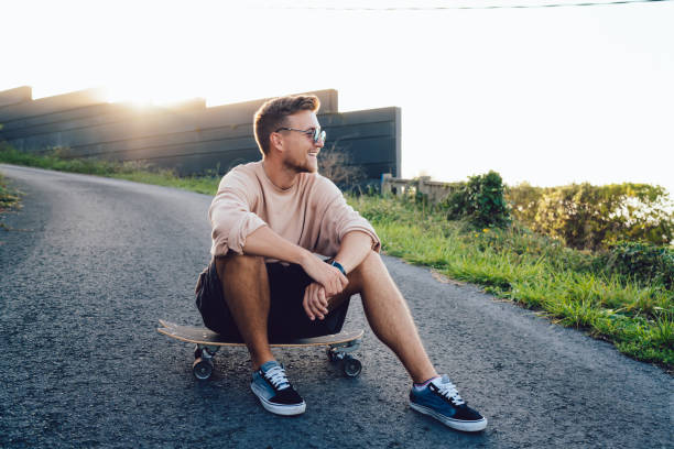istock Cheerful young skater resting on skateboard 1415865526