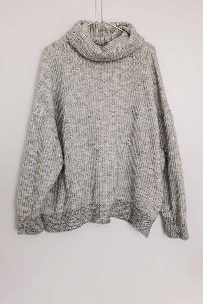 istock Warm woolen knitted sweater on the hanger 1415866908