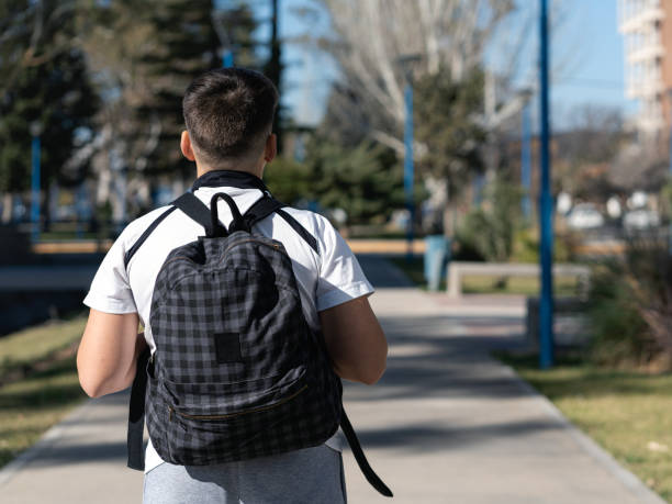 istock Schoolboy posing backwards on his way to school 1415867608