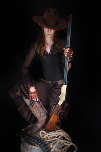 istock wild west girl with rifle 1415867971