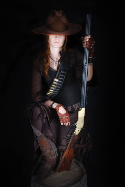 istock wild west girl with rifle 1415867994