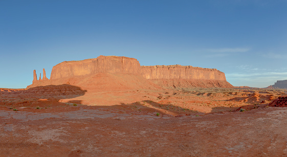 the Three Sisters rock formation with big butte in  Monument Valley Navajo Tribal Park