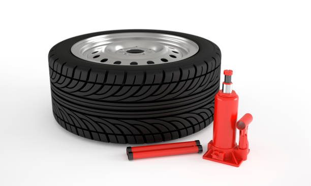 istock Car wheels with hydraulic jack 1415871569