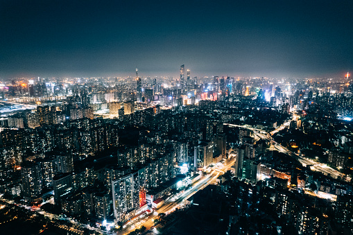 Drone view of city at night with traffics and buildings.