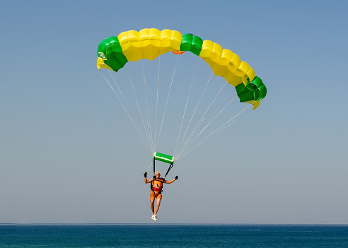 June 29, 2022. Rio de Janeiro, Brazil. Old man landing his parachute on Barra da Tijuca beach in Rio de Janeiro.