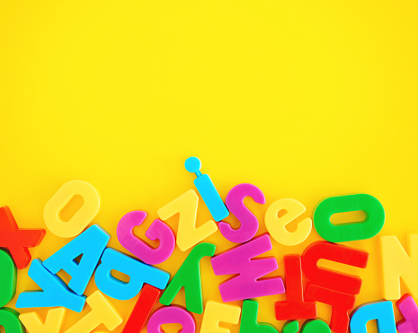 Alphabet background with a collection of letters on a vibrant yellow background