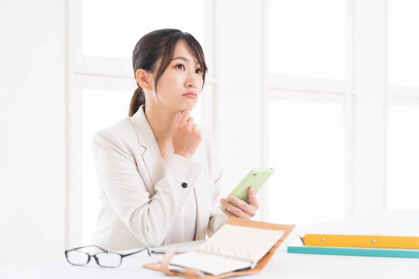 istock young asian woman who see a smart phone,think, 1415888028