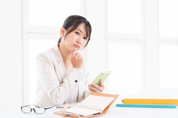 istock young asian woman who see a smart phone,think, 1415888080