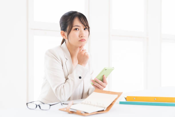istock young asian woman who see a smart phone,think, 1415888094