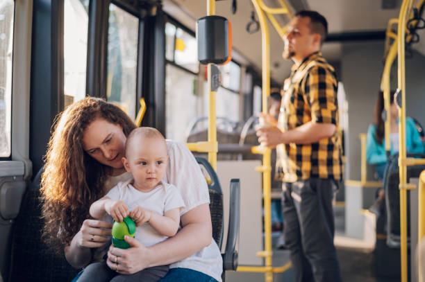 istock Mother and her child riding in a bus during a day. 1415892096