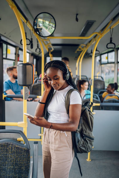 istock African american woman using smartphone while riding a bus 1415892106