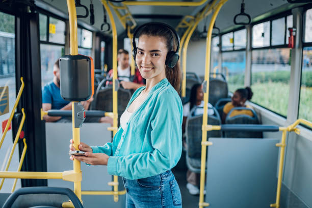 istock Woman paying a bus ticket via smartphone during a ride 1415892110