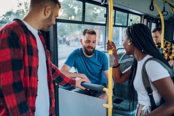 istock Multiracial group of friends talking while riding in a bus 1415892119