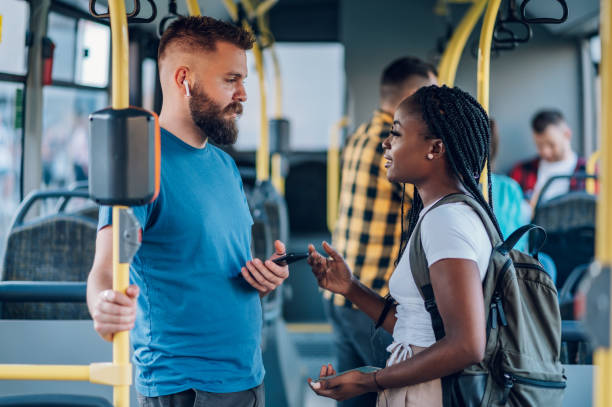 istock Multiracial friends talking while riding a bus in the city 1415892123
