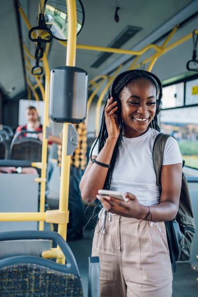 istock African american woman using smartphone while riding a bus 1415892124