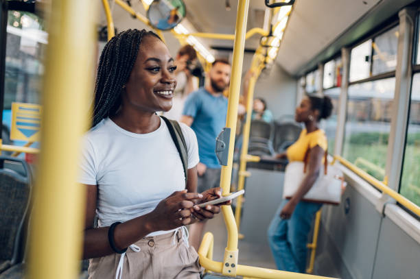 istock African american woman using smartphone while riding a bus 1415892145