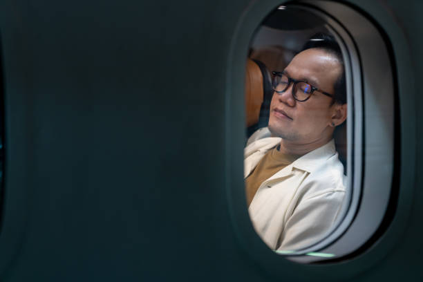 istock Asian man sleeping on passenger seat while travel on airplane 1415892163