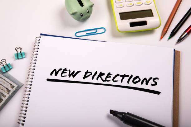 istock NEW DIRECTIONS. Text on paper. Office supplies on the table 1415892348