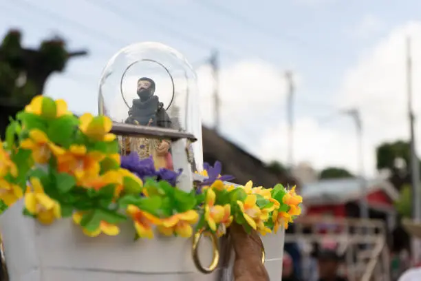Image of Santo Domingo de Guzman in miniature traveling in a small wooden boat in the Managua festivities