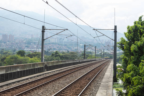 Metro rails with Medellin, Colombia in the background Skyline of Medellin, Colombia seen from a metro station metro medellin stock pictures, royalty-free photos & images