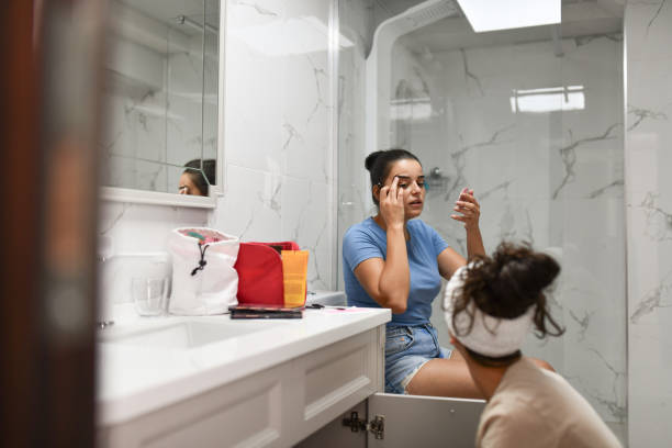istock Lesbian Girl Asking For Help From Her Girlfriend About Eyebrows In Bathroom 1415894625