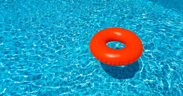 istock Brown ring floating in blue swimming pool. Inflatable ring, rest concept 1415899880