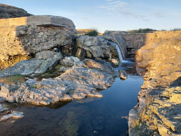 istock a small river with a waterfall among the rocks 1415905601