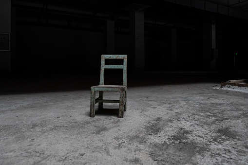 An isolated chair in the basement square