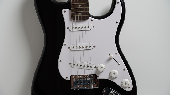 Black and white electric guitar on white background