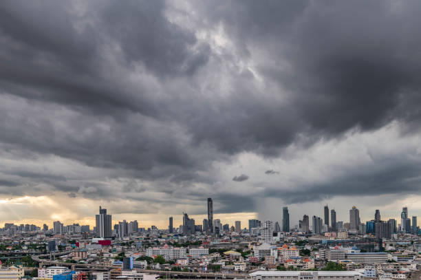 Modern city under dramatic stormy rainy clouds. stock photo