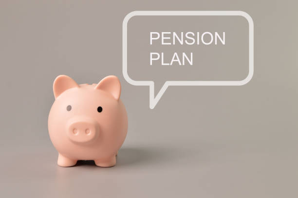 istock Front view of piggy bank with text PENSION PLAN. 1415914577