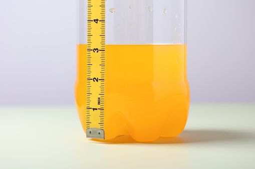 Diet concept. Orange juice and measuring tape