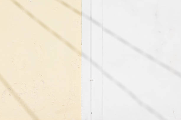 Concrete wall of two different shades with shadow pattern.