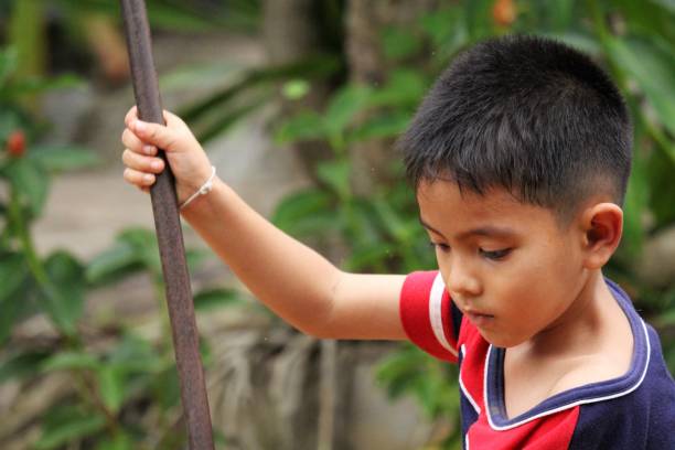 istock Asian Thai little boy play in the backyard 1415919681