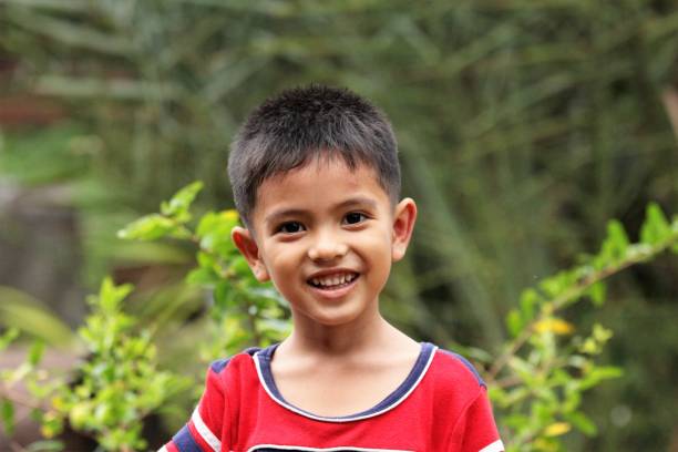 istock Asian Thai little boy in the backyard 1415919684