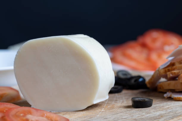 istock Fresh cow's milk cheese is cut on a board 1415922370