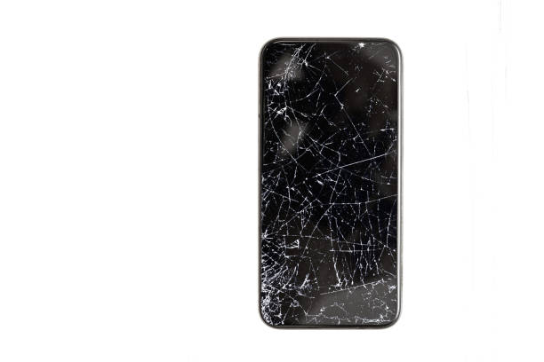 Black broken touch screen phone with cracked screen isolated on a white background stock photo