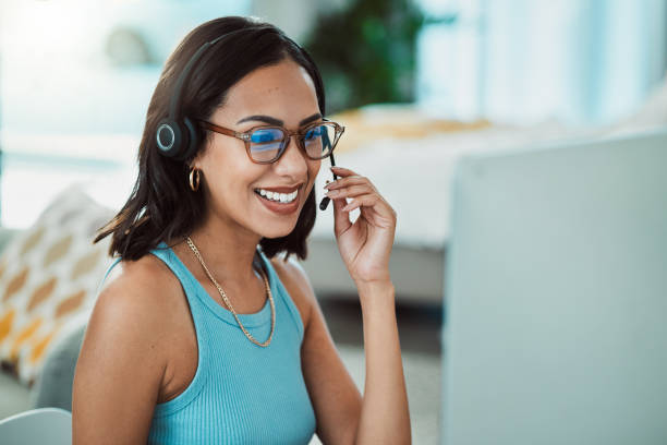 istock Call centre, customer service and agent with computer talking to customers, helping or answering calls in office. Smiling, happy or friendly helpdesk operator, secretary and contact us client support 1415925313