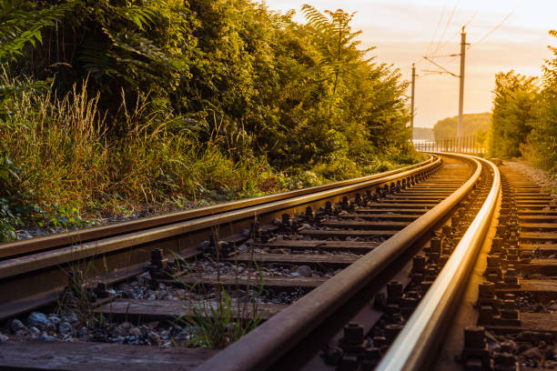 istock Railway tracks go into distance against backdrop of sunset. 1415927415