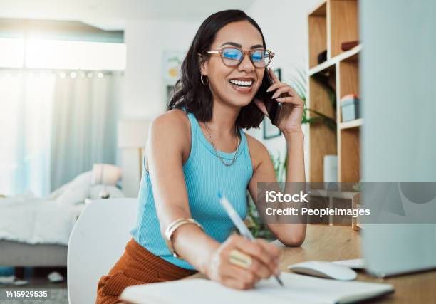 Creative Entrepreneur Talking On Business Phone Call Writing In Notebook And Planning A Project Working Remote At House Happy Learning And Young Woman Doing Freelance And Making Notes In Book Stock Photo - Download Image Now