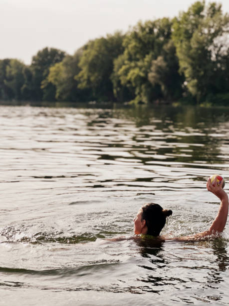 istock Woman in river playing volleyball 1415929680
