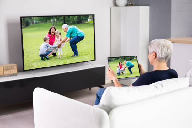 istock Woman Watching TV Through Tablet Television 1415929965