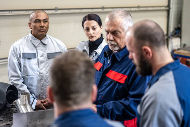 istock Group of people standing side by side around work desk 1415931185