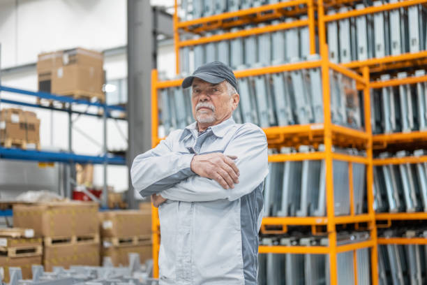 istock Mature man standing in warehouse with arms crossed 1415931216